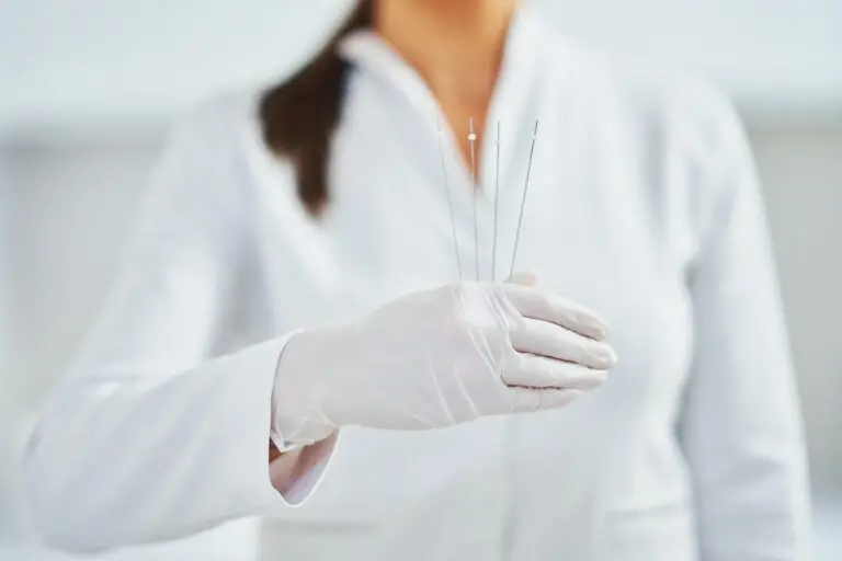 Picture of woman holding cosmetic threads in wearing gloves